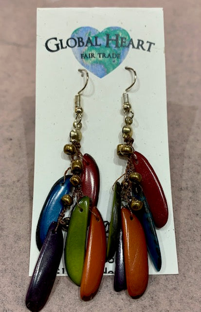 Earrings made of dyed tagua nut slices in blue, green and red on a Global Heart card
